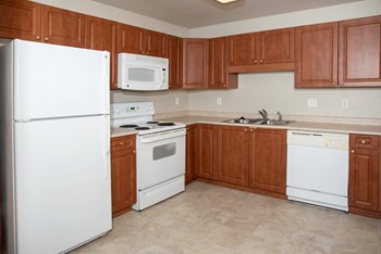 The Como 1 bedroom, spacious kitchen with cherry cabinets
